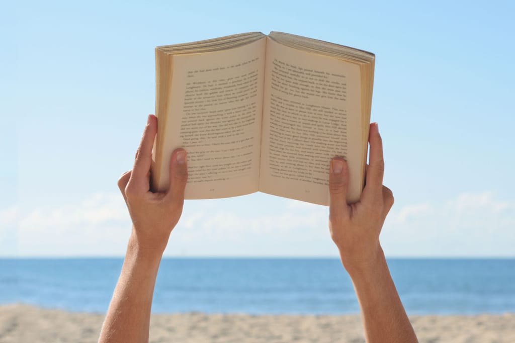 Summer Productivity Essentials: Person reading on the beach