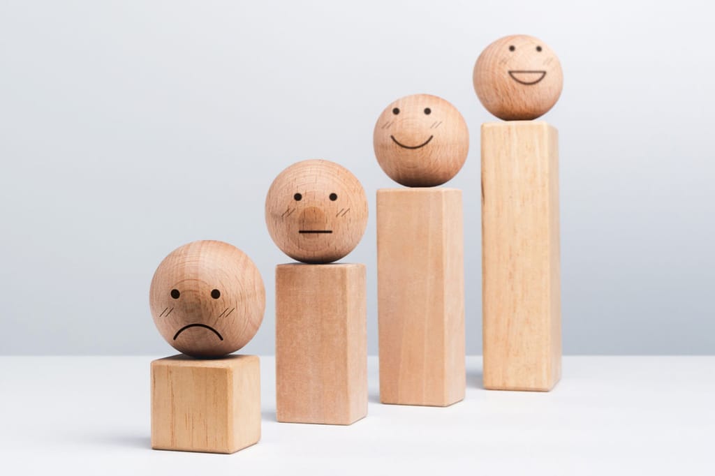 Wooden blocks that look like people lined up like a bar graph to symbolize people analytics metrics.