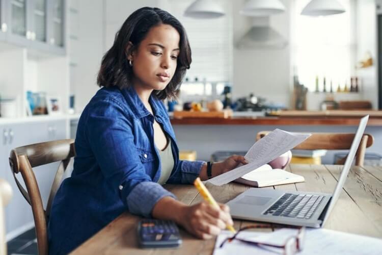 A woman actively engaged in a project at work.