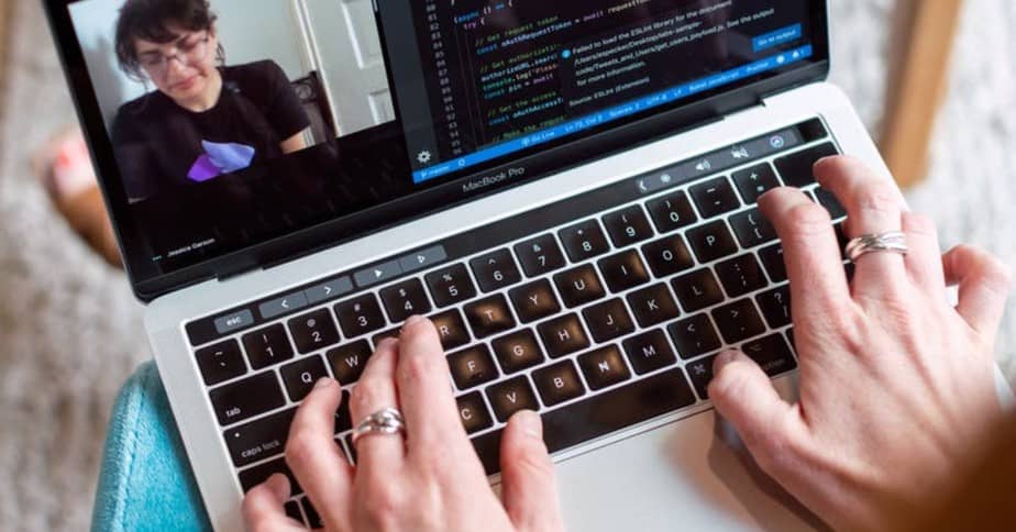 A woman's hands typing on a laptop, which runs productivity management software.