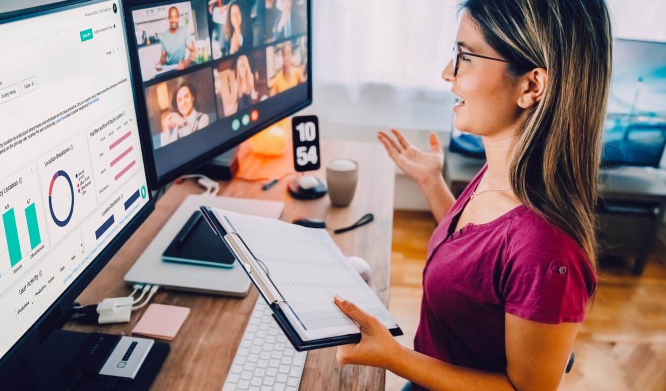 Remote employee looking through the top 5 reports for remote and hybrid teams.