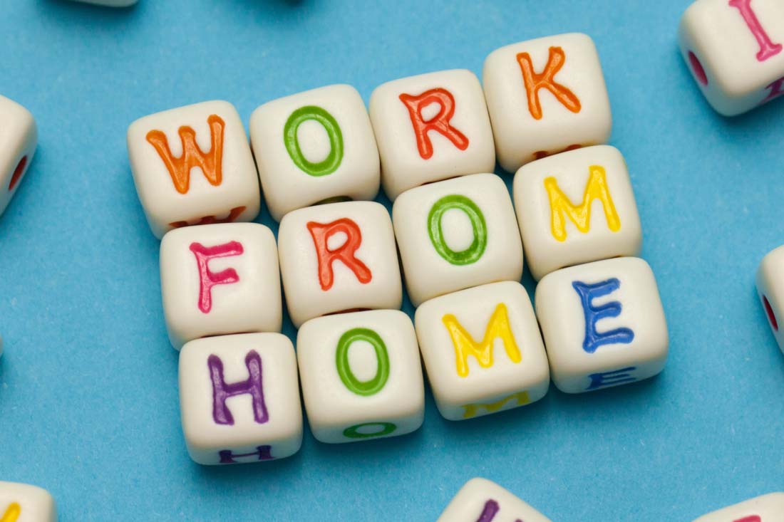 WORK FROM HOME spelled out with dice that have colored letters.