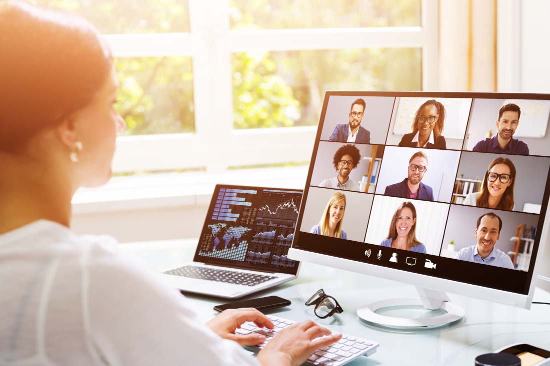 A manager on a call with her team discussing how to support remote employees.