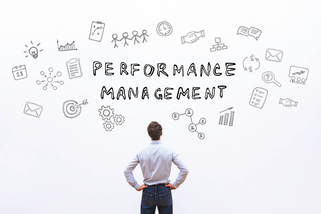 A business leader looking at the words performance management.