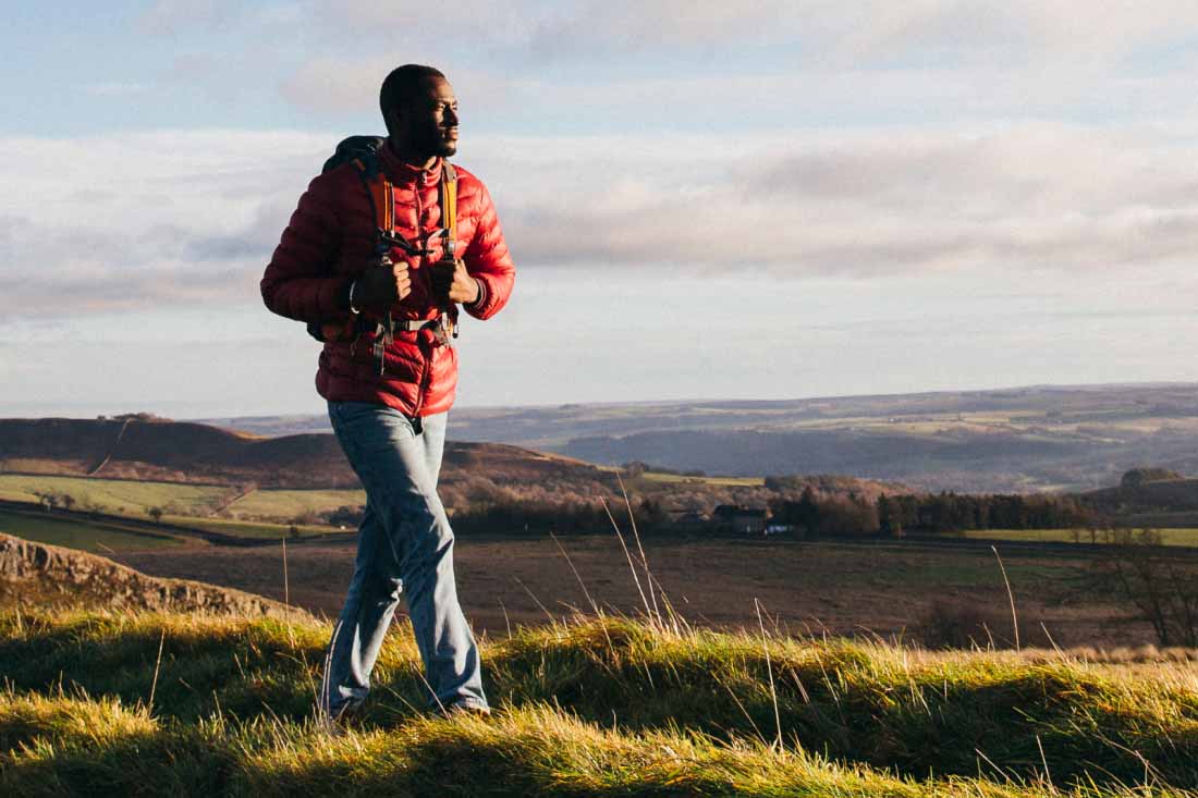 An employee taking a hike to symbolize employee wellbeing.