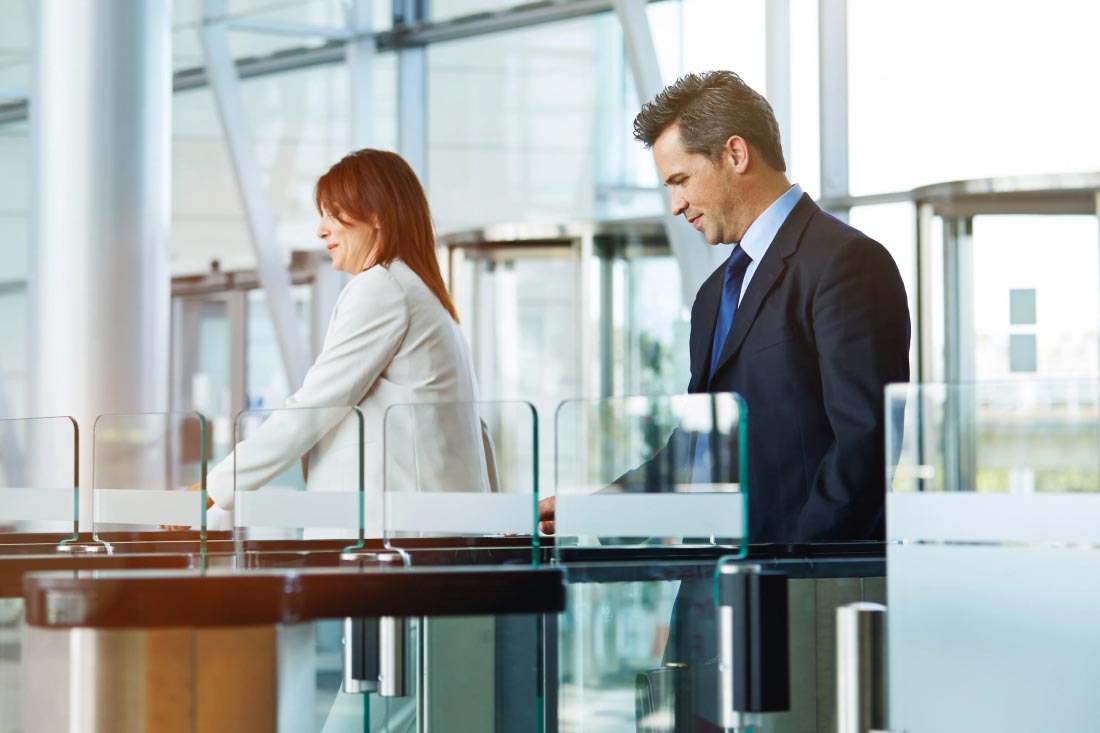 Business people going through security into an office building.